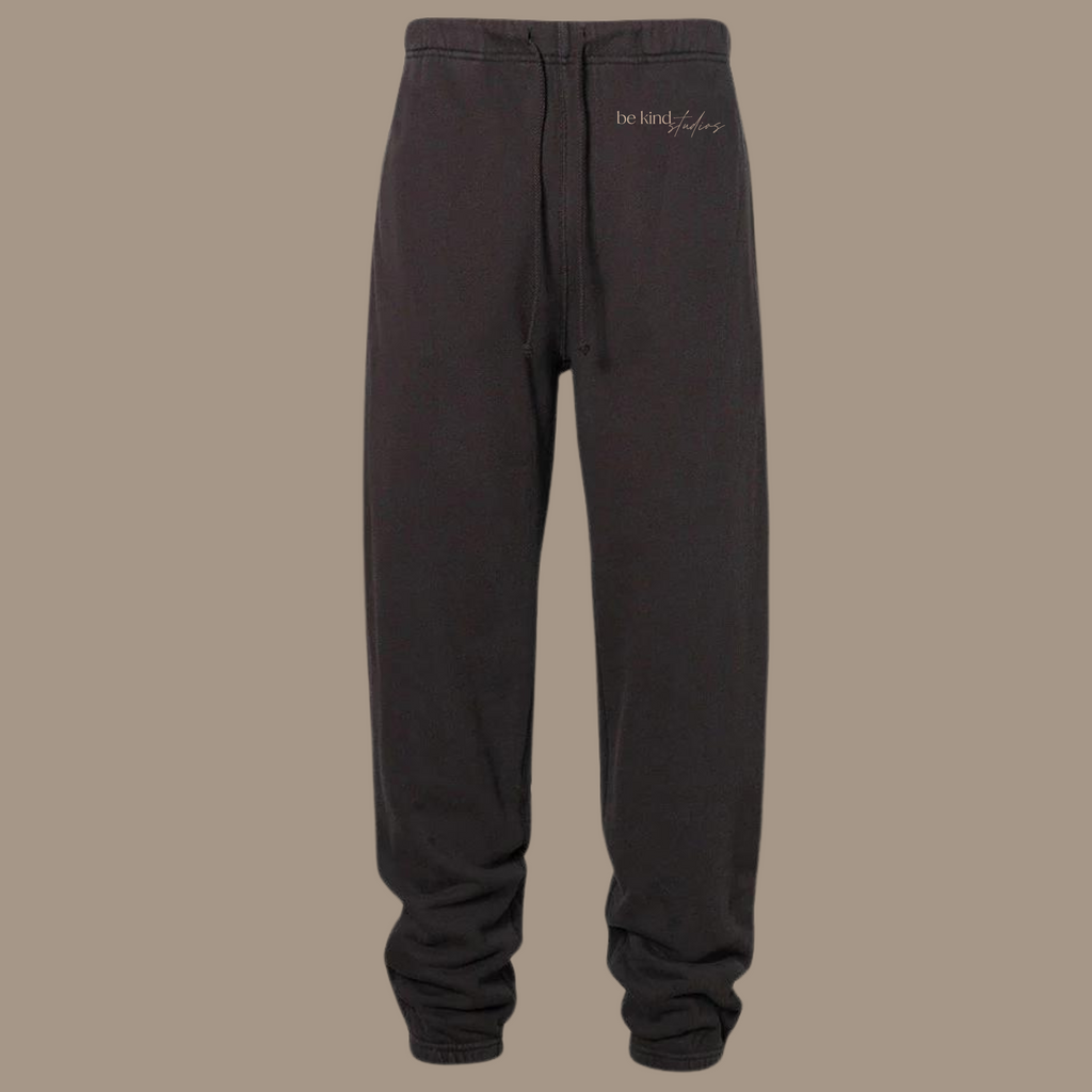Scrunch leg sweat pants with the words "be kind studios" embroidered on the front.