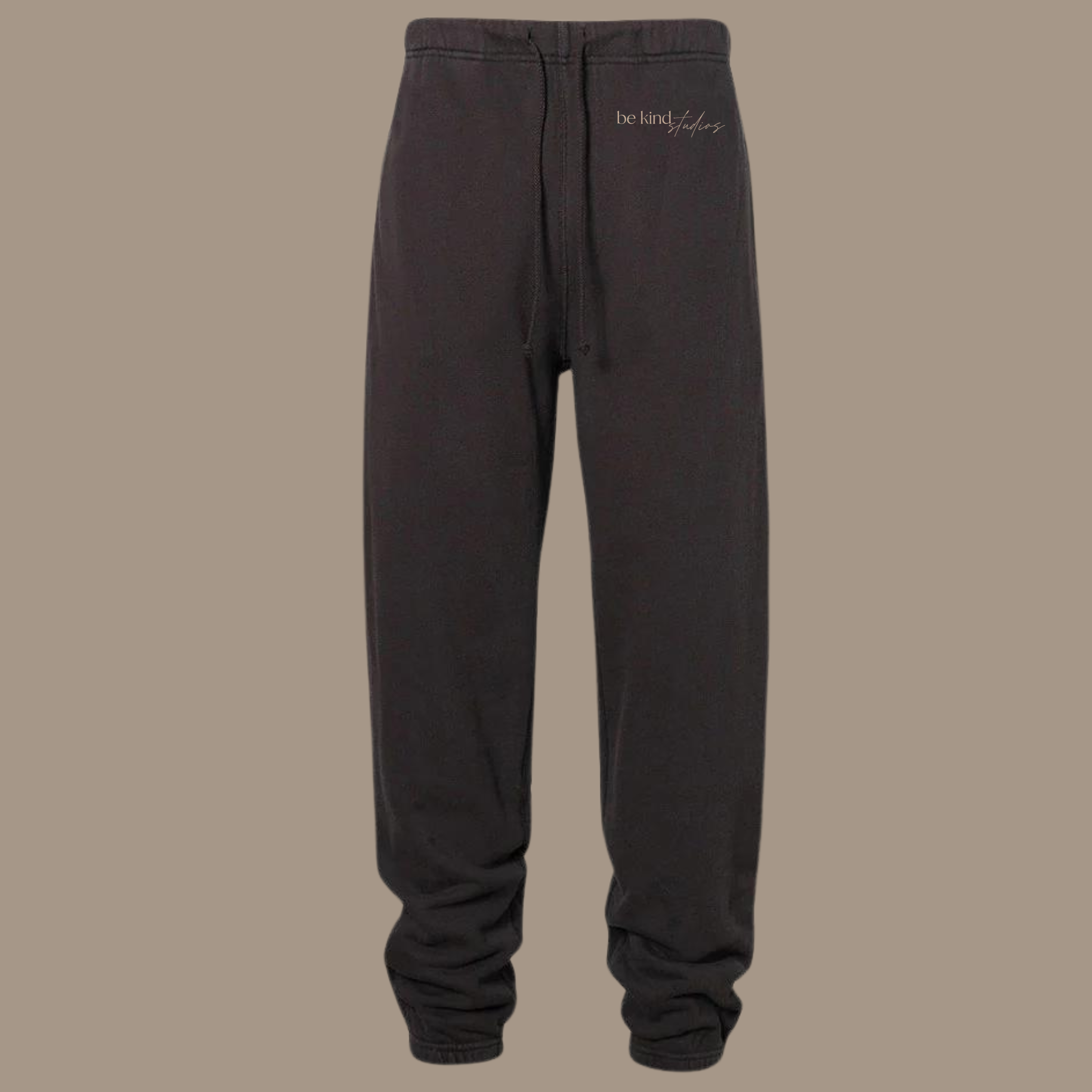 Scrunch leg sweat pants with the words "be kind studios" embroidered on the front.