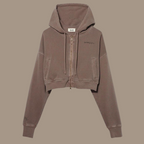 Crop zip hoodie with the words "be kind studios" embroidered on the front.