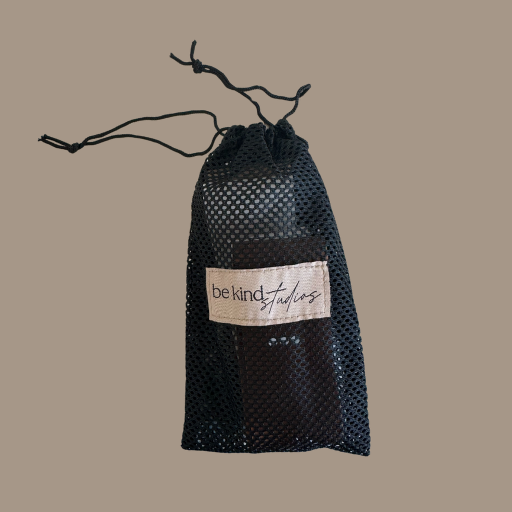 booty bands in mesh bag with the logo "Be kind studios" embroidered on the front