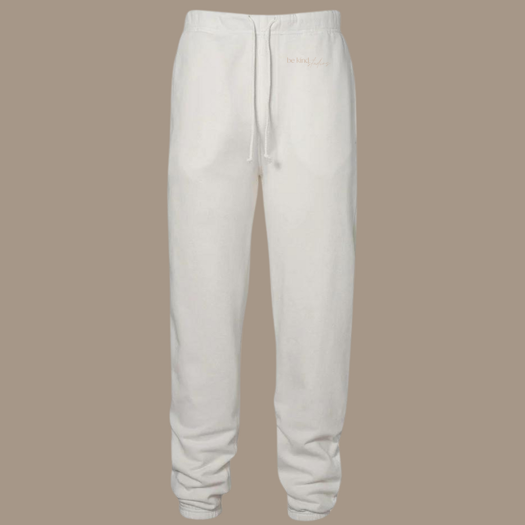 Scrunch leg sweat pants with the words "be kind studios" embroidered on the front.