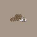 Gold marble hair clip that says Be Kind Studios