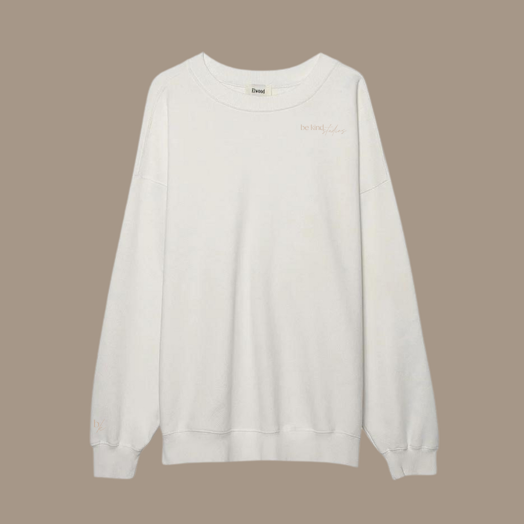 Oversized crew neck with the words "be kind studios" embroidered on the front.